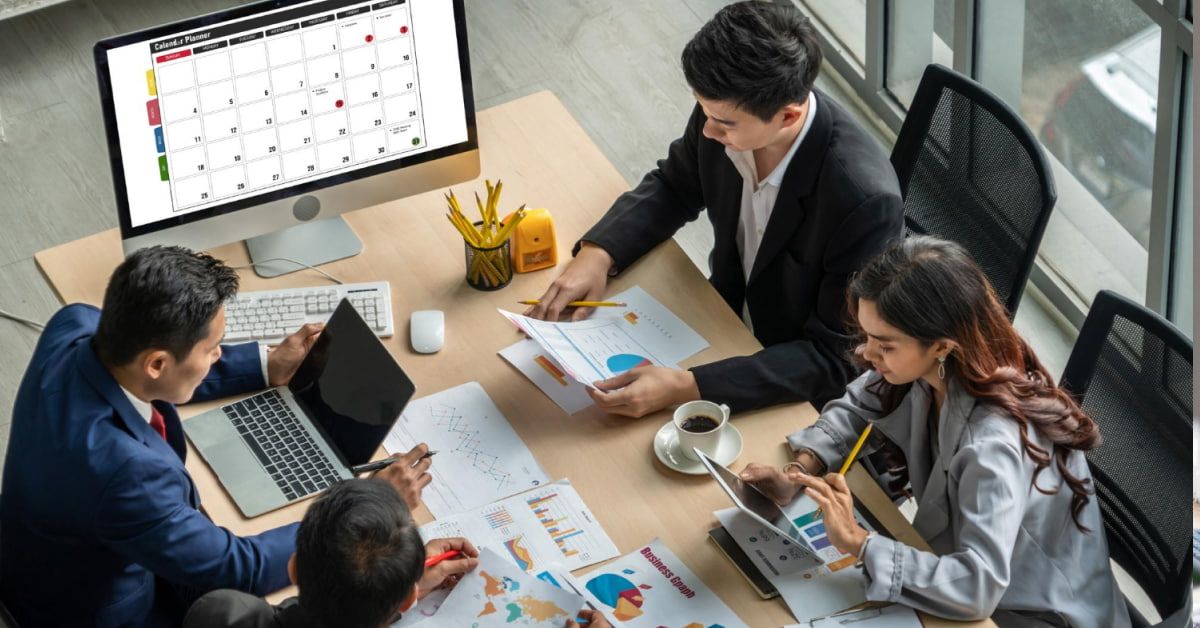 A group of people at a table, analyzing data and patterns