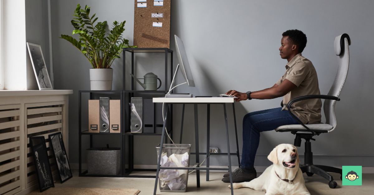 An employee working remotely with a lab dog under the table