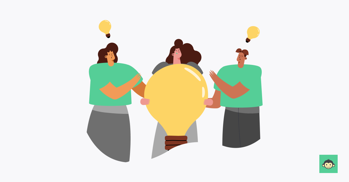 An employee holding a huge bulb while two employees having each bulb on their head
