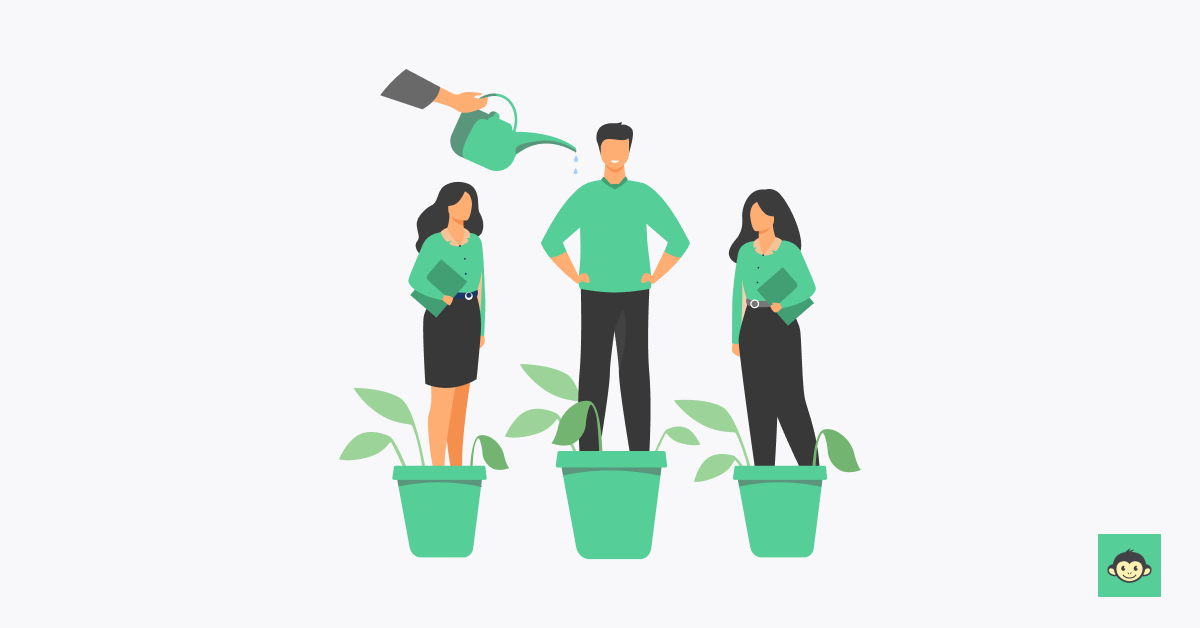A leader watering employees who are standing plant pots