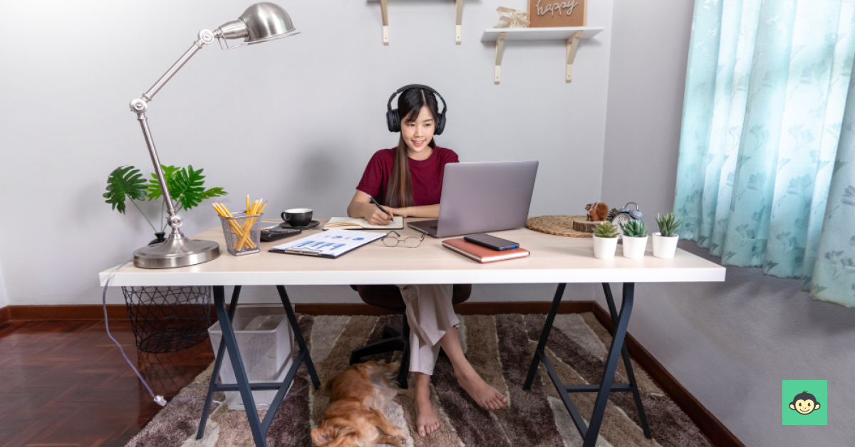 Employee is working remotely with a dog under the table 