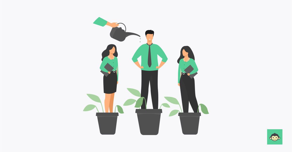 Employer watering employees who are standing on plant pots
