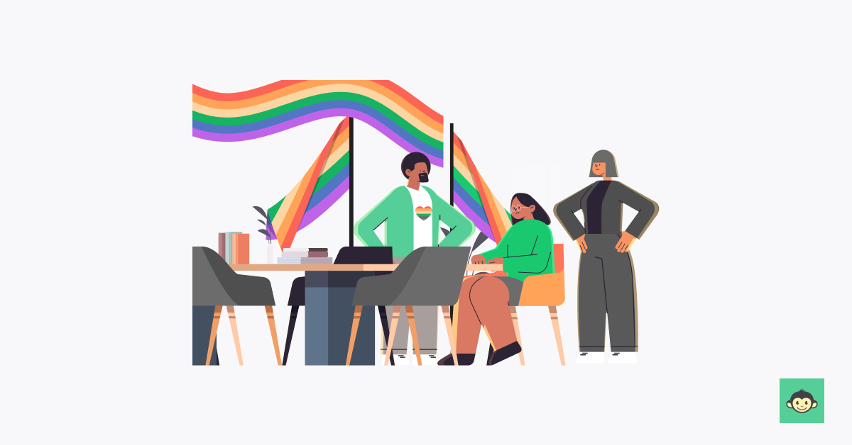 Employees are working in the workplace with pride flags behind them 