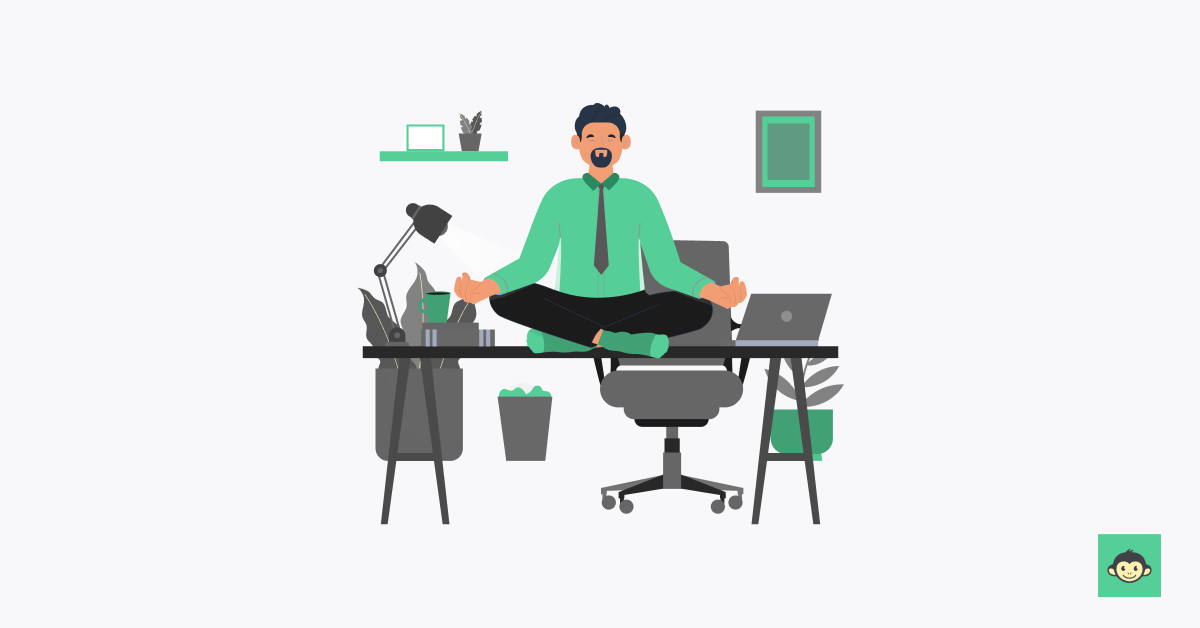 Employee meditating in the workplace on the table 