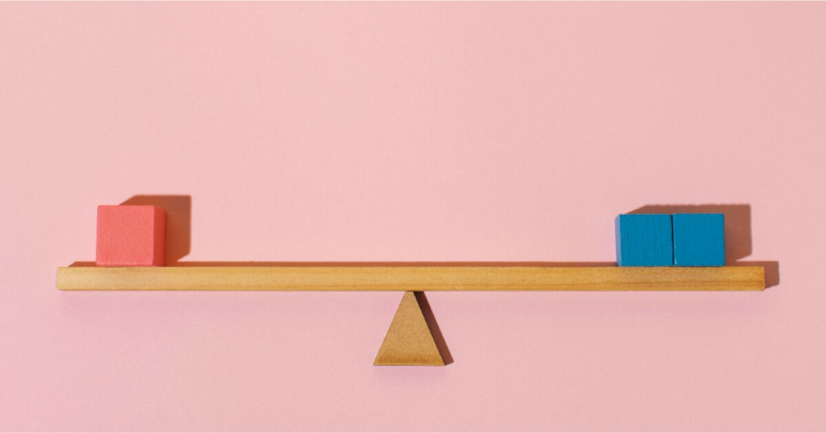 A level wooden scale with red and blue blocks