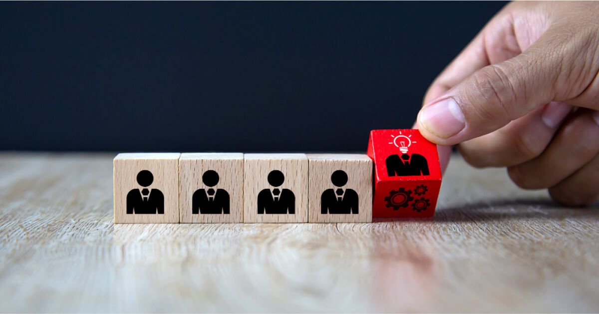 Red cube next to wooden cubes