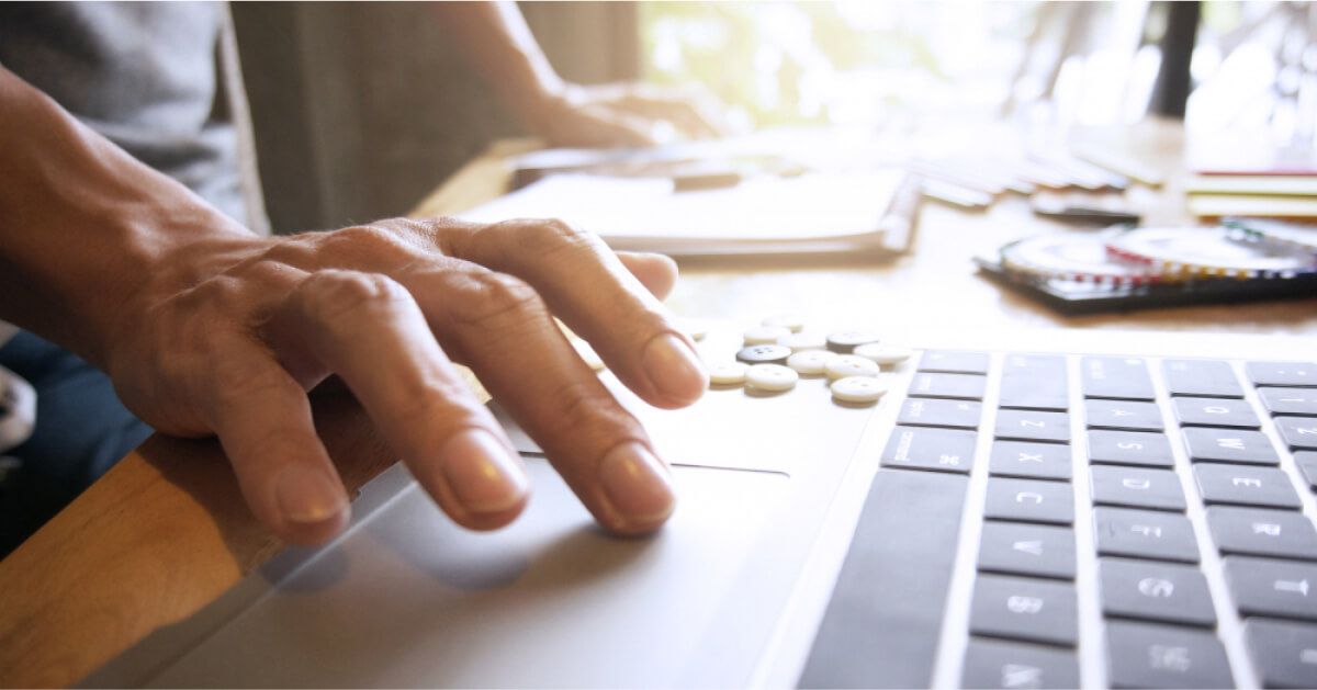 Employee working with his laptop in the workplace