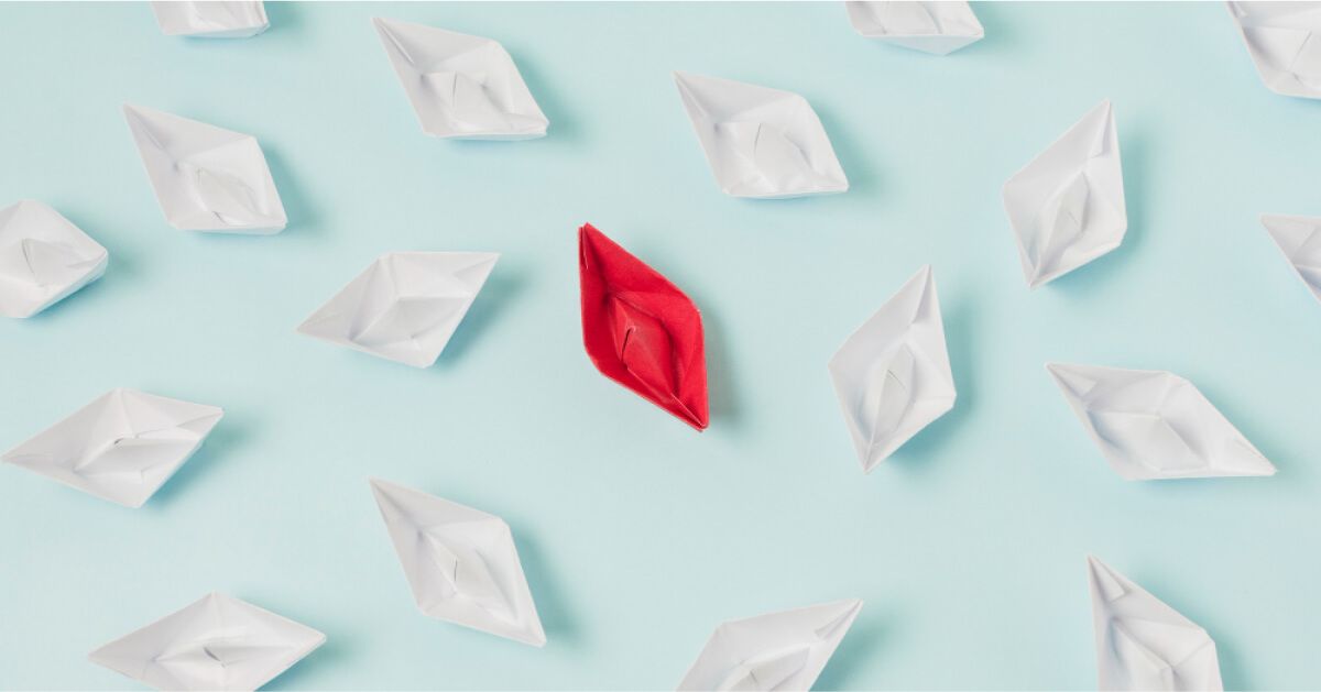 Red boat in the midst of white boats