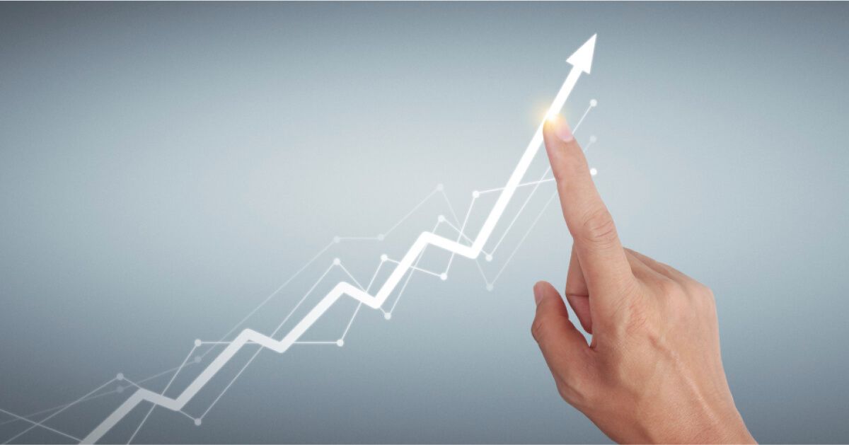 A hand guiding an upward trend
