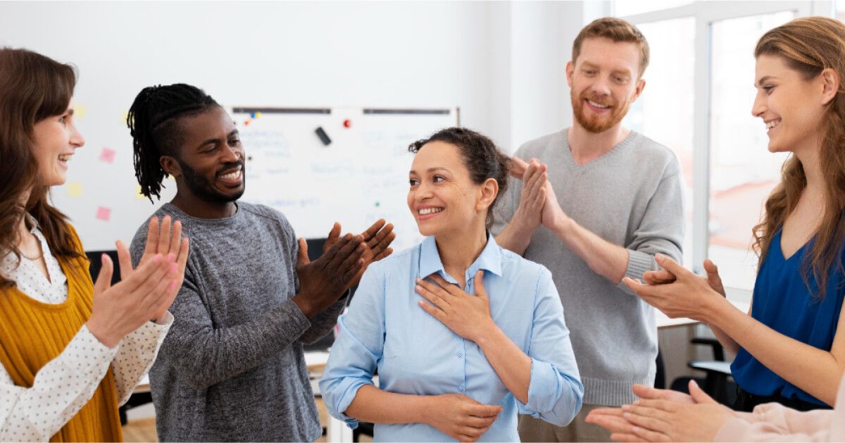 People applauding around a grateful employee
