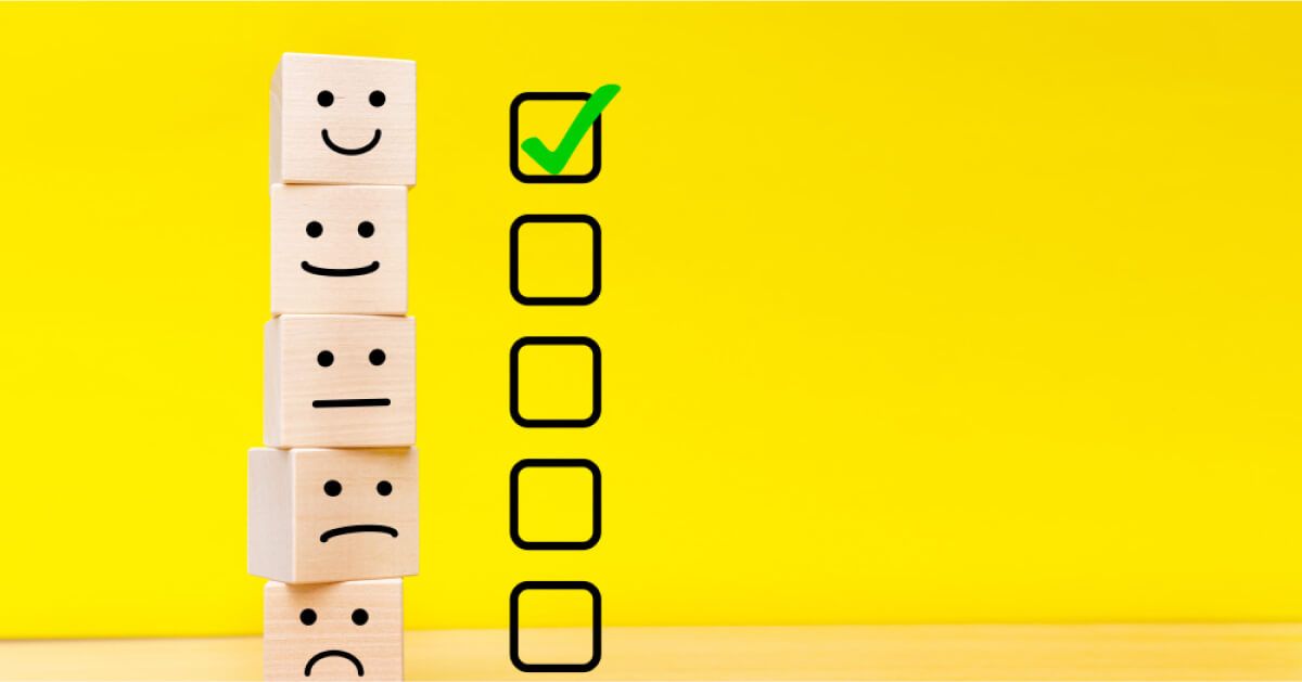 Stack of wooden blocks with reactions on them and checkboxes next to them