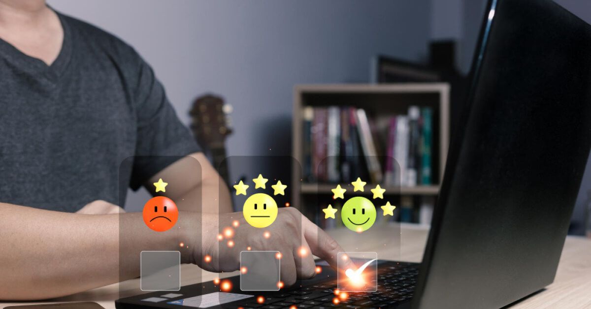 Person using a laptop with holographic rating visuals on top