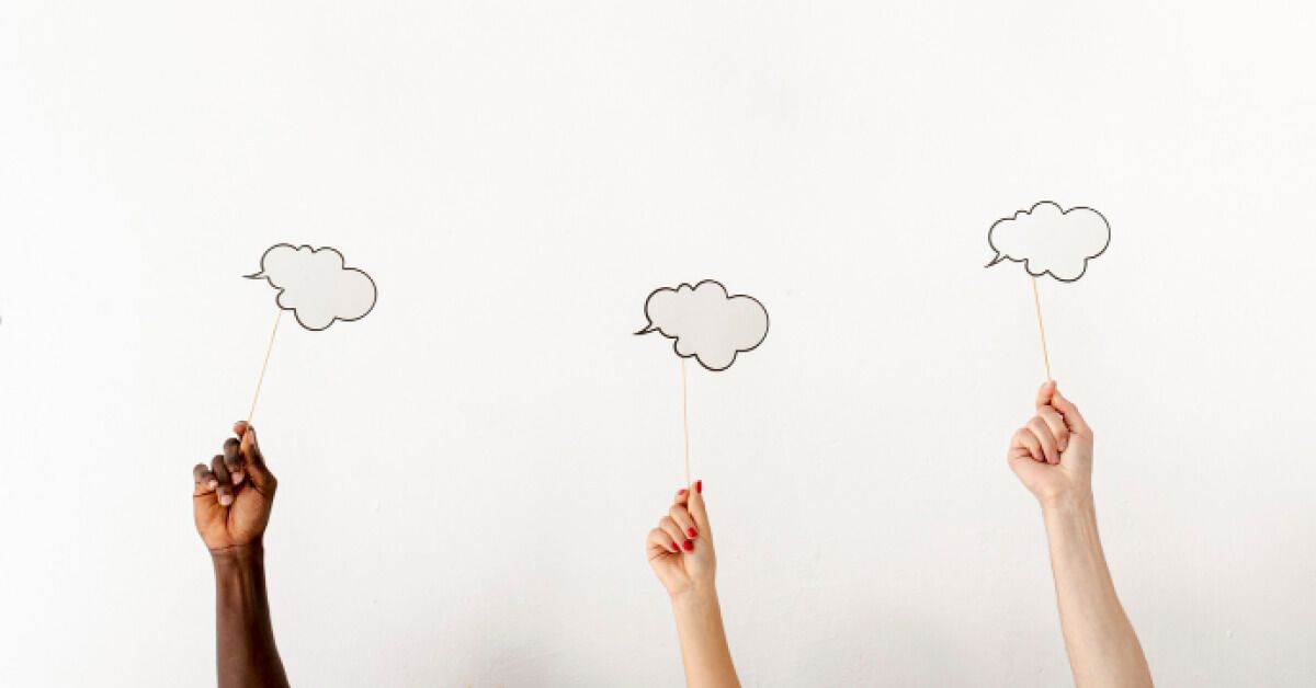 People holding up sticks with dialogue clouds
