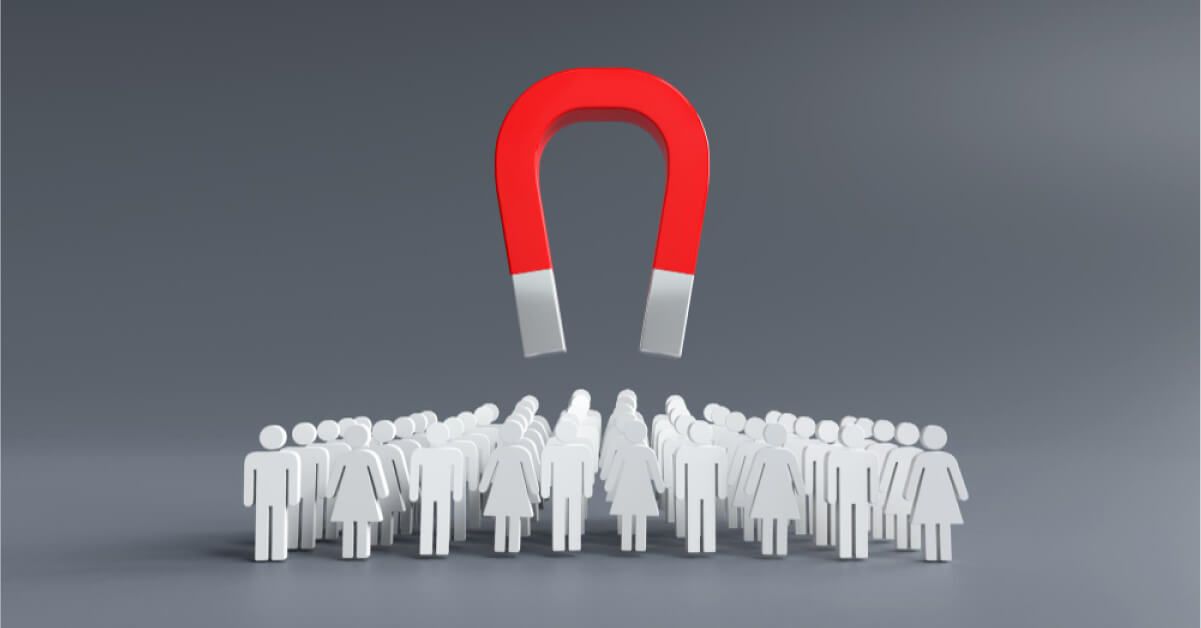 A horseshoe magnet floating over a group of human figurines