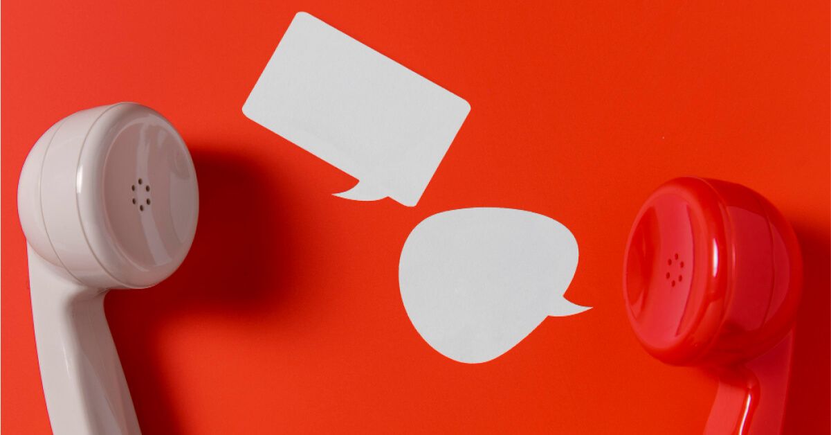 Two phone receivers with paper cutouts of dialogue boxes