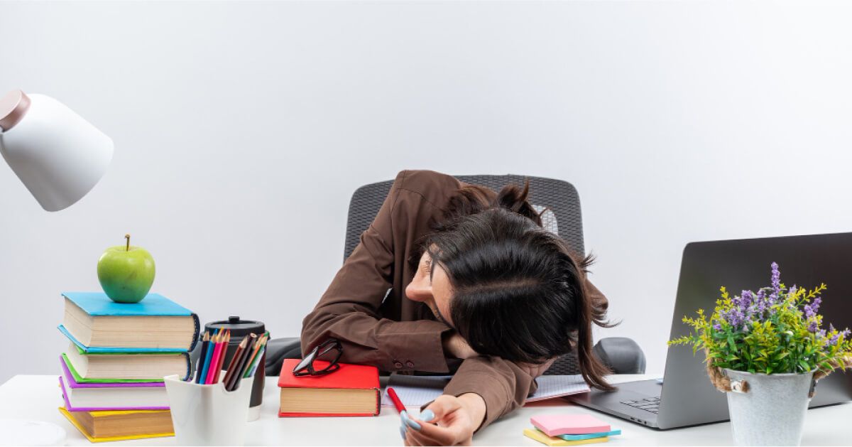 An employee sleeping in the desk