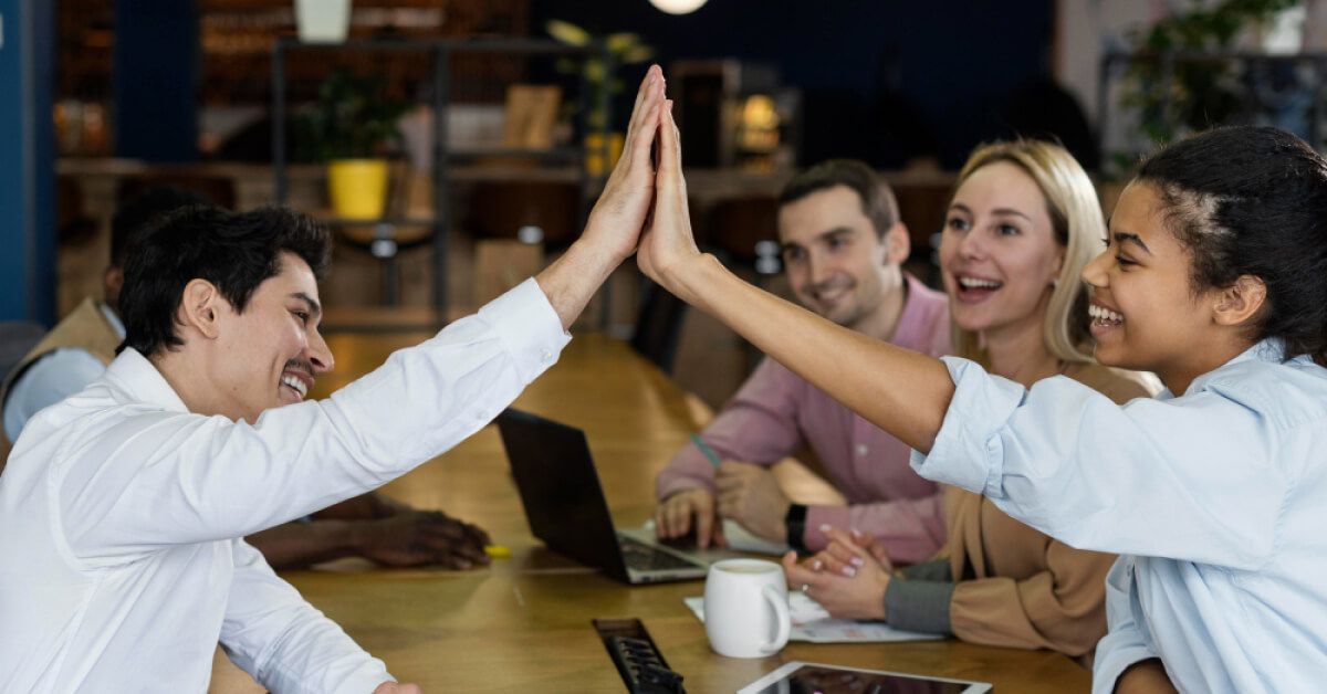 Group of employees giving high five
