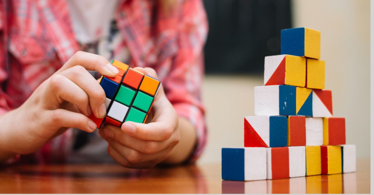 Girl playing with cube puzzle