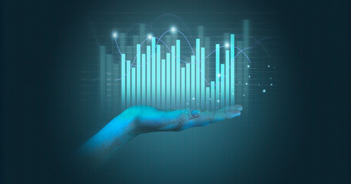 Person holding holographic visuals of charts