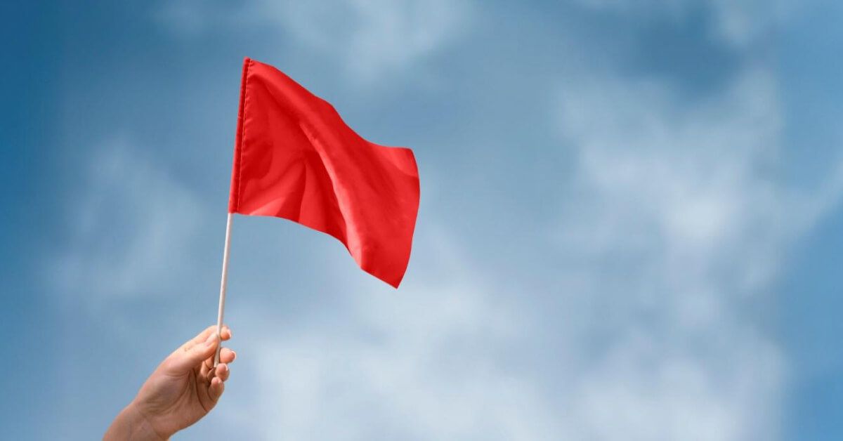 Person holding a red flag