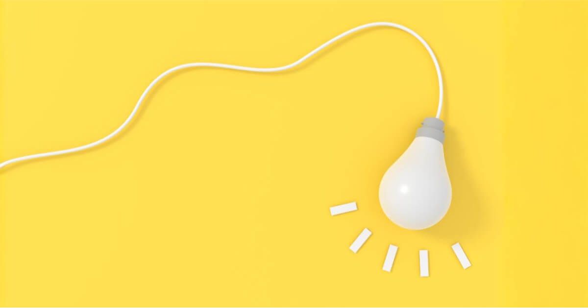 Wired lightbulb over a yellow backdrop