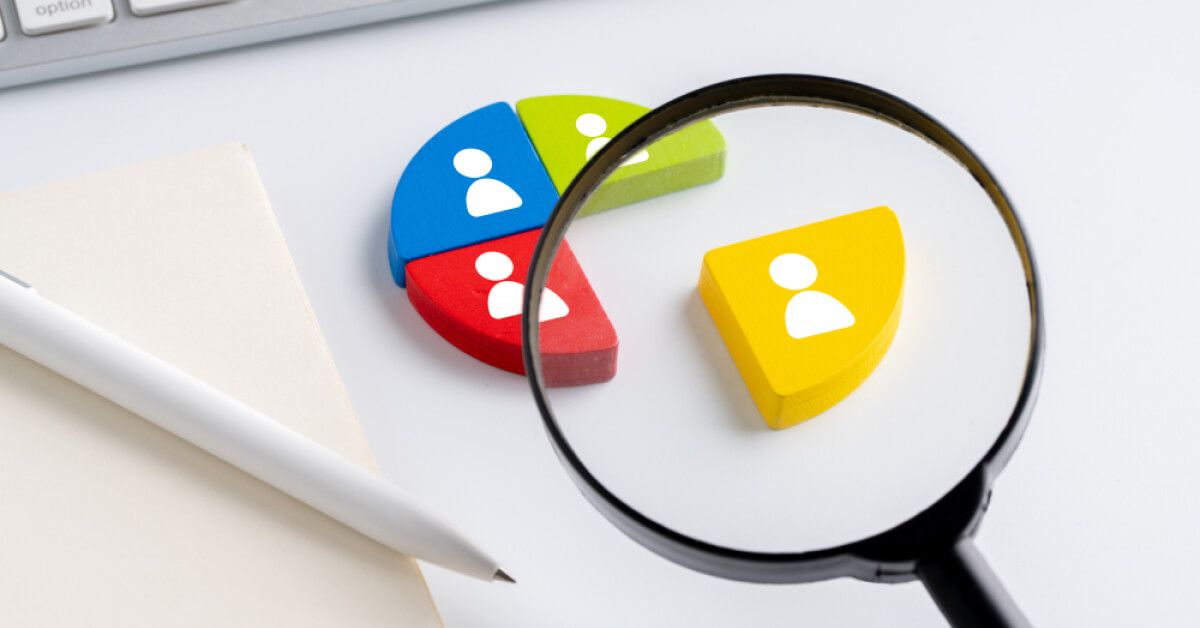 Magnifier glass over a coloured segment with an employee graphic