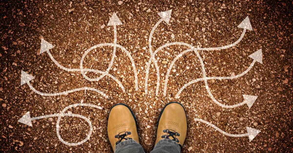 A set of arrows leading in different directions in front of a person