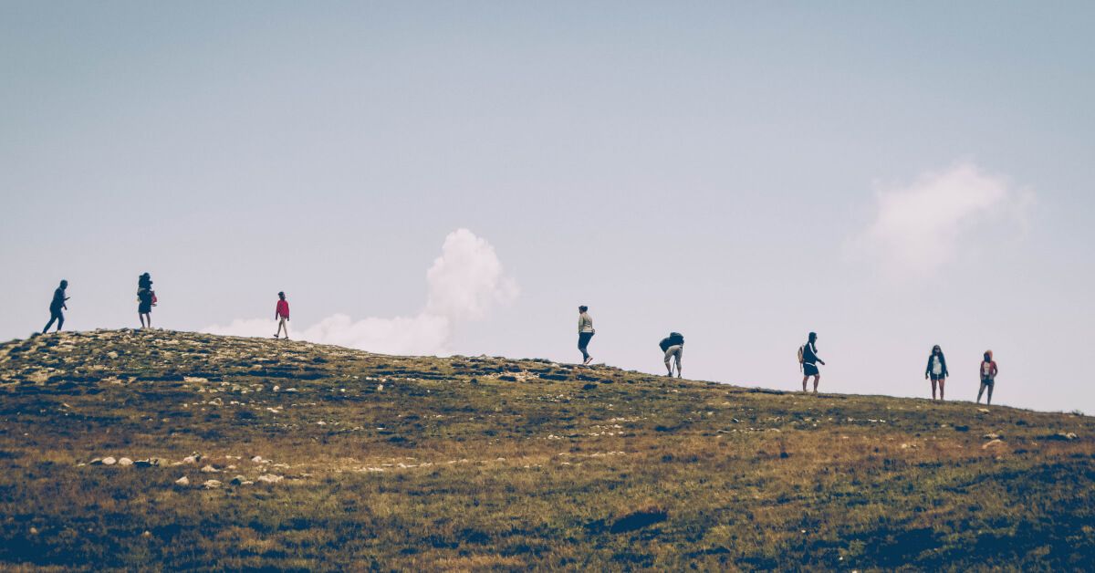 A group of people climbing a hill