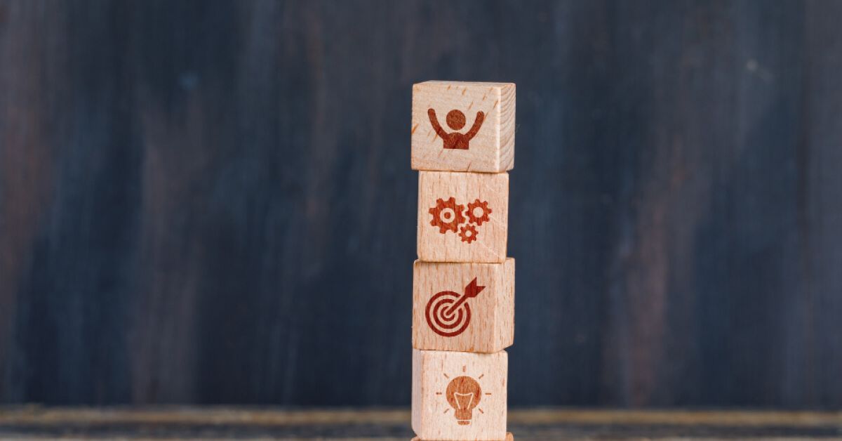 Stack of wooden blocks with vector visuals on them