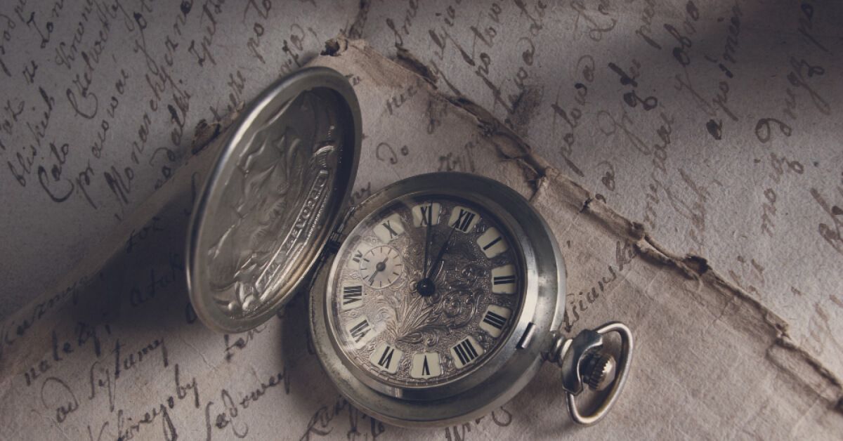 Antique pocket watch over sheets