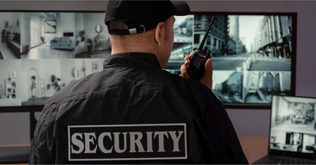 Security personnel looking over camera feeds