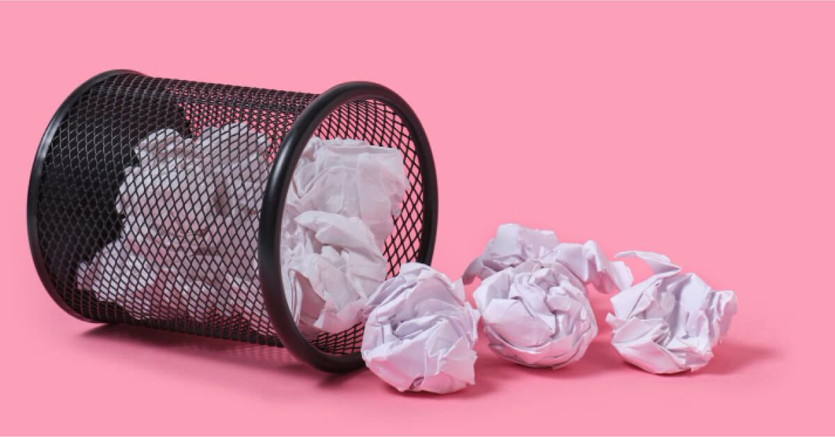 Crushed up paper balls around a dustbin