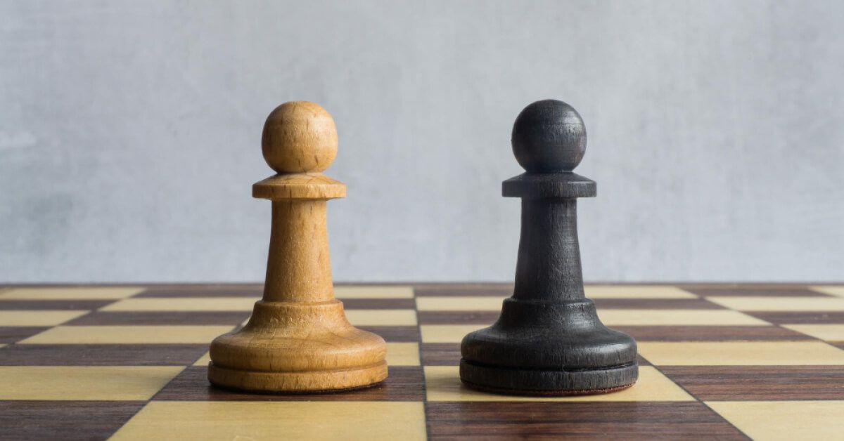 Black and white pawns next to each other