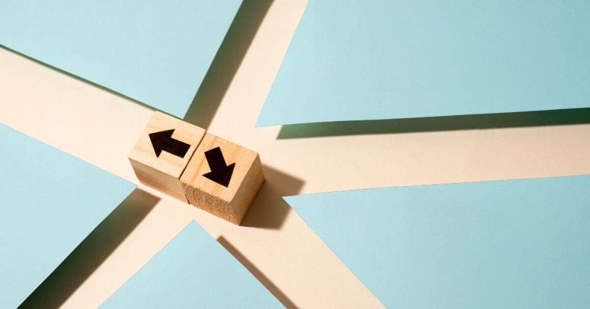 Wooden blocks with arrows pointing in different directions
