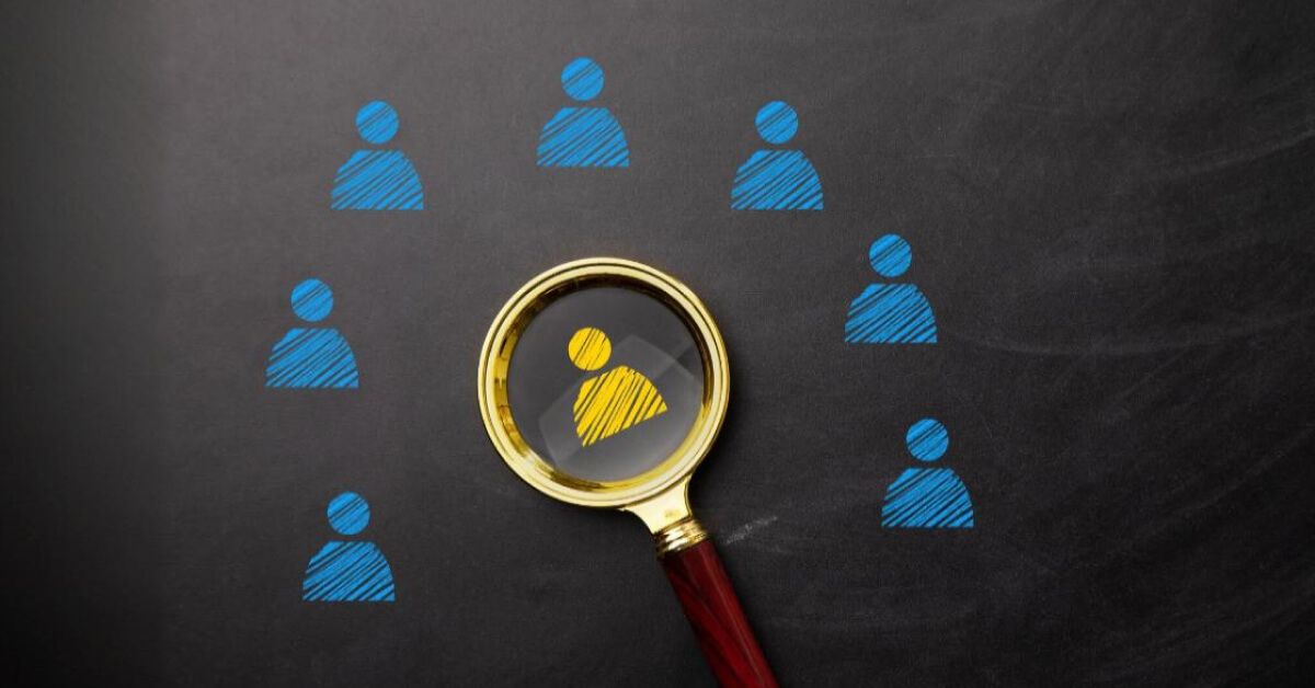 Magnifier glass pointing at a yellow employee icon