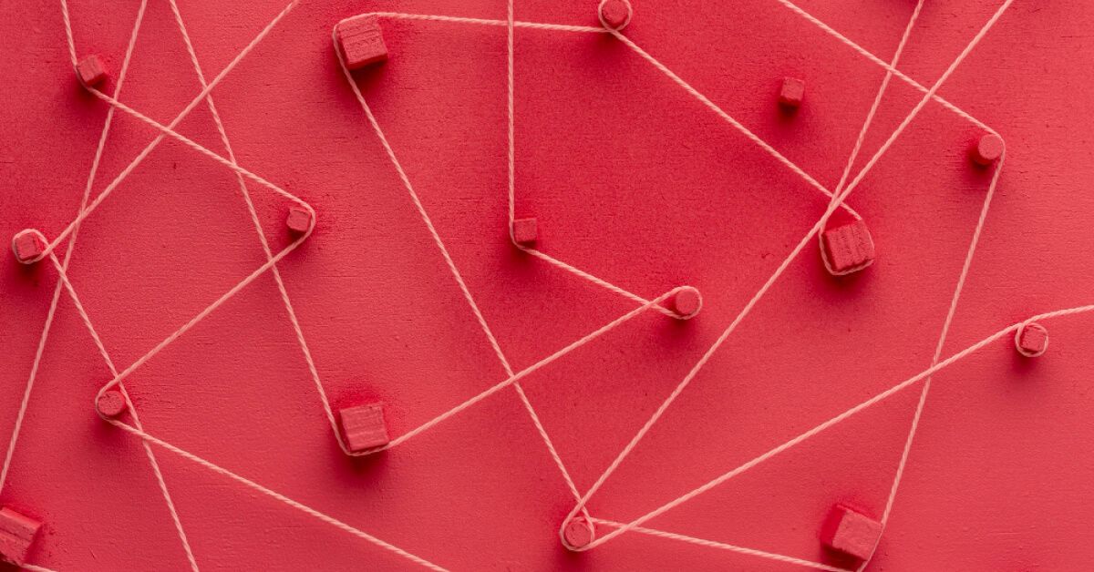 A string going around pucks on a red backdrop