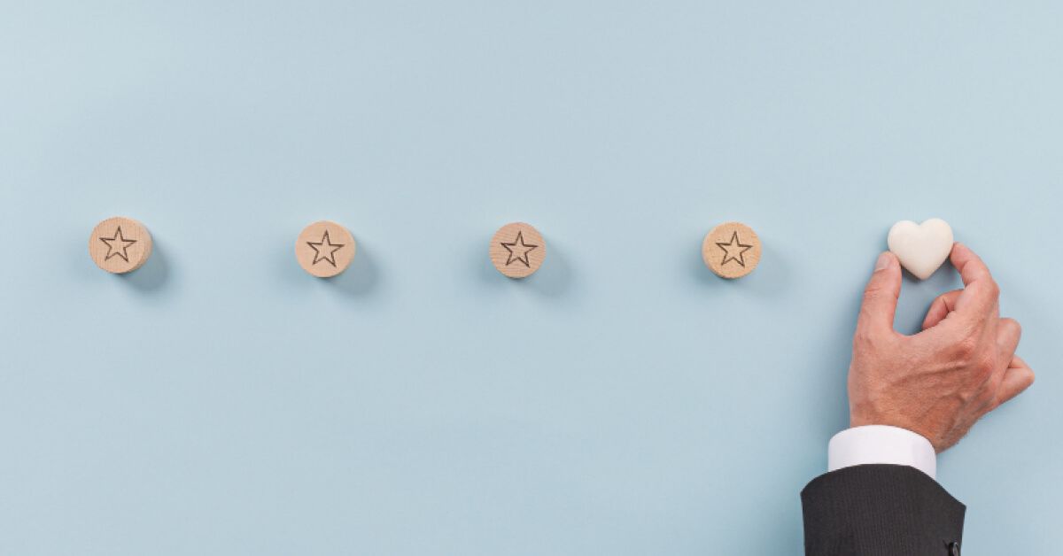 Person placing a heart shaped chip next to a series of chips with stars