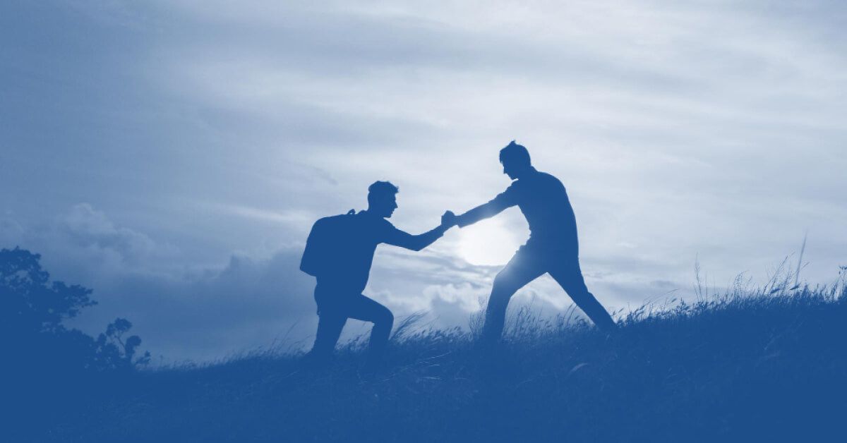A man helping another