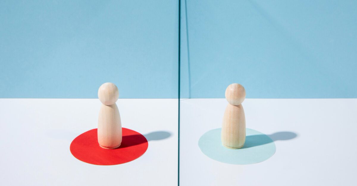 Two wooden pawns placed on different colours