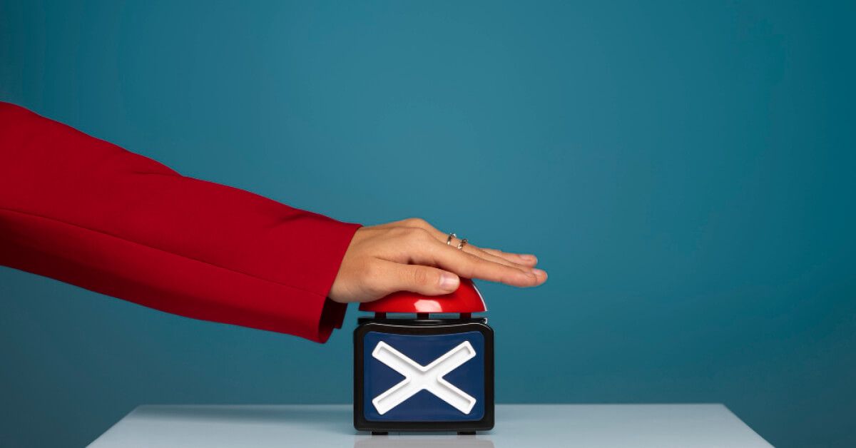 A red buzzer being pressed