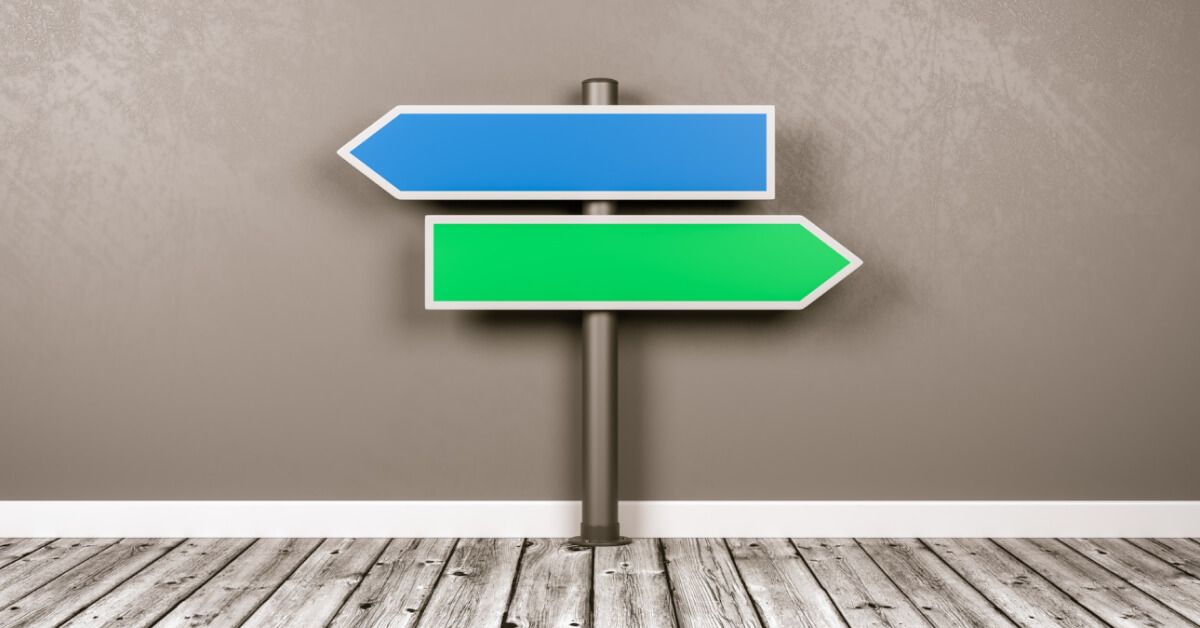 Blue and green direction boards in opposite directions
