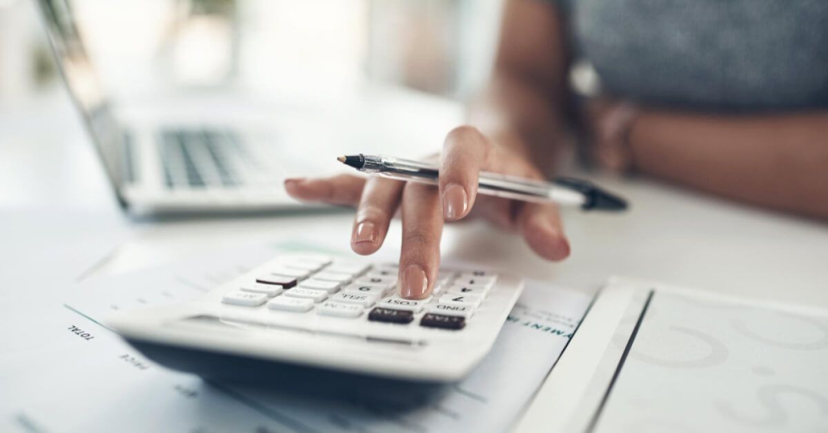 Person using a calculator on a workdesk