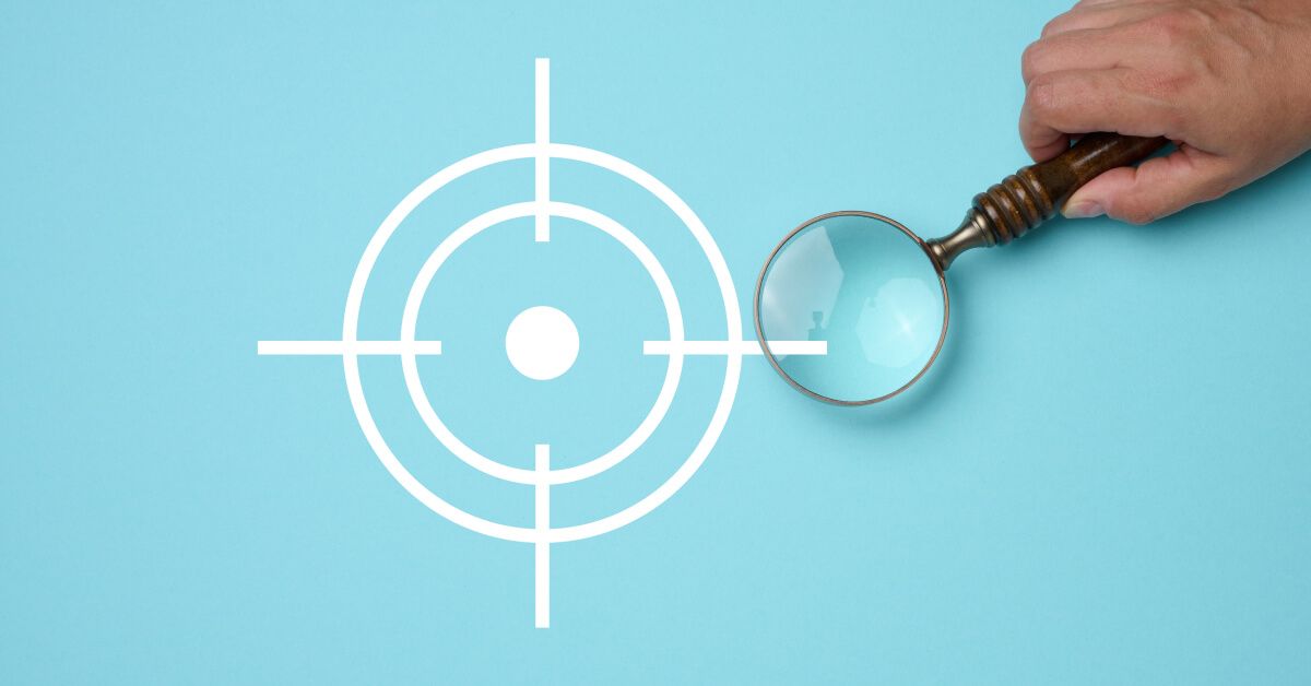 Person placing a magnifier over a target icon