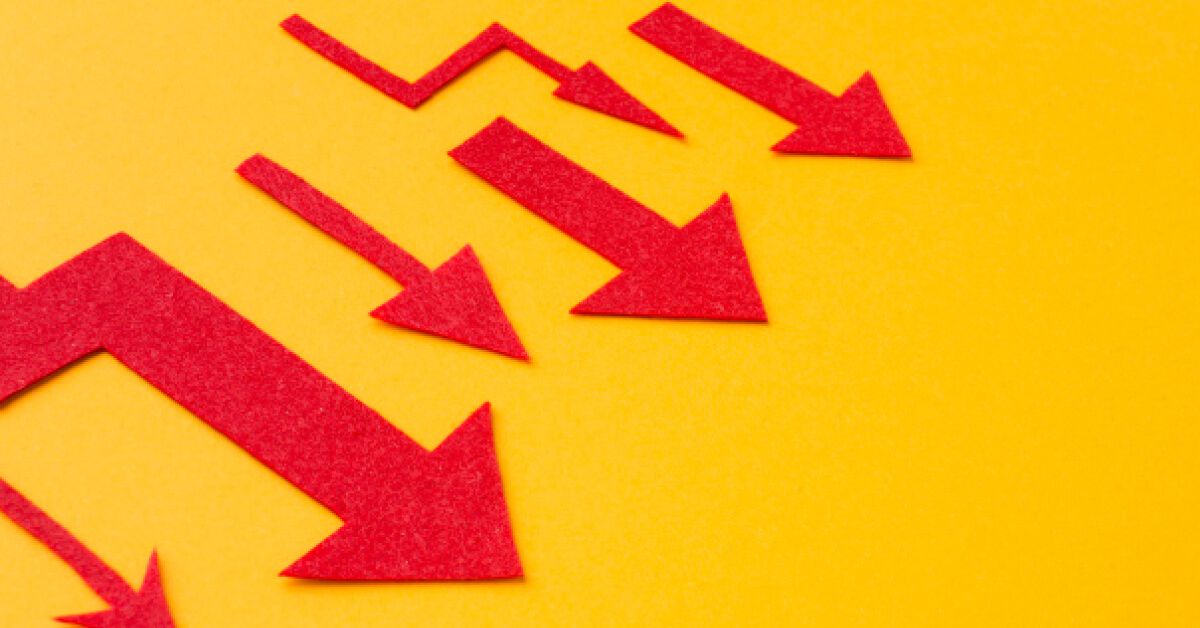 Downward moving red arrows against an yellow backdrop