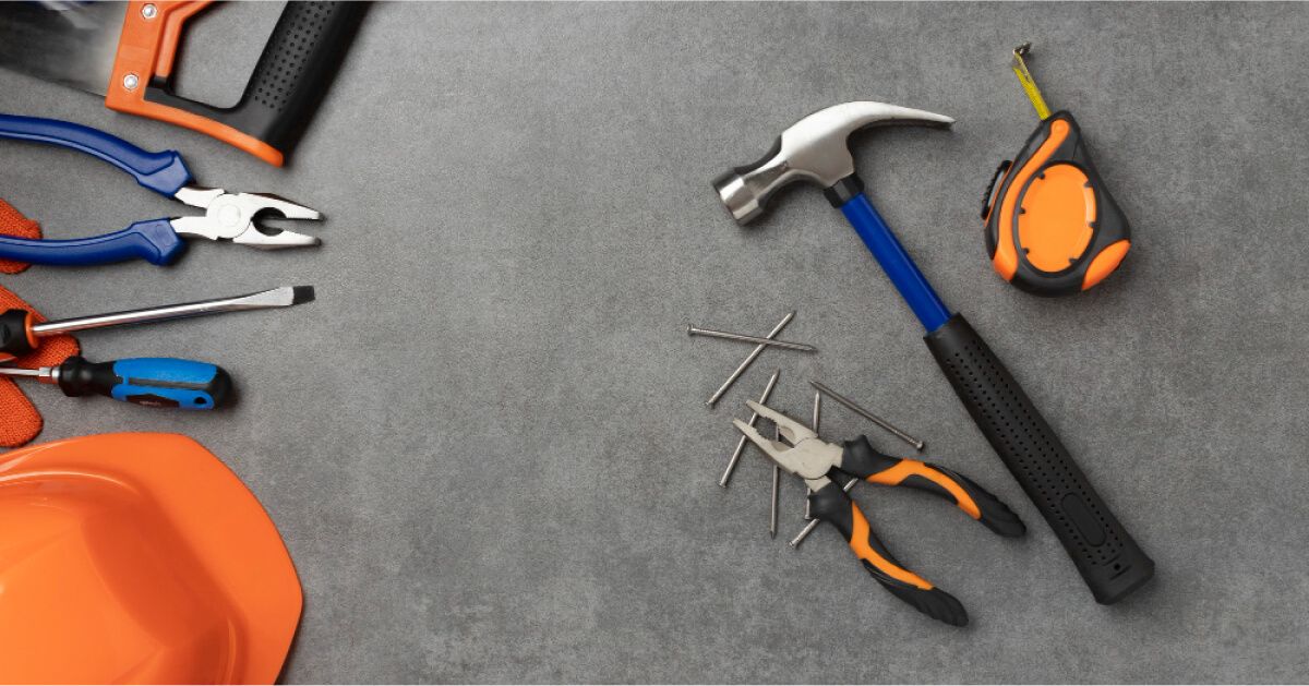 Carpentry tools over a grey backdrop