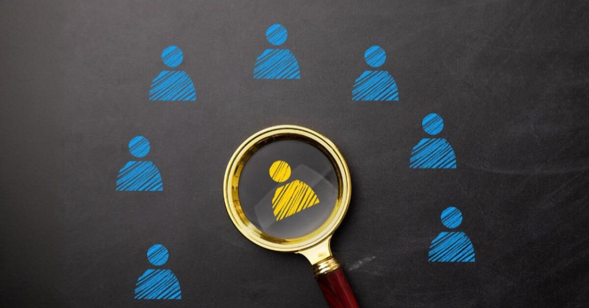 Magnifier glass over an yellow employee graphic