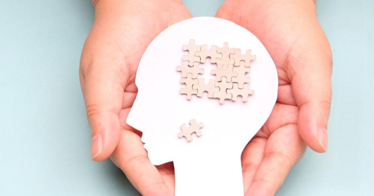 Interconnected puzzle pieces inside a paper-cut figurine