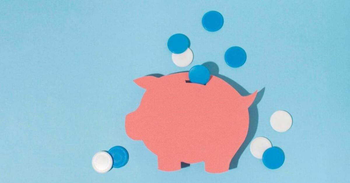Paper cutout of a piggybank with blue and white coins