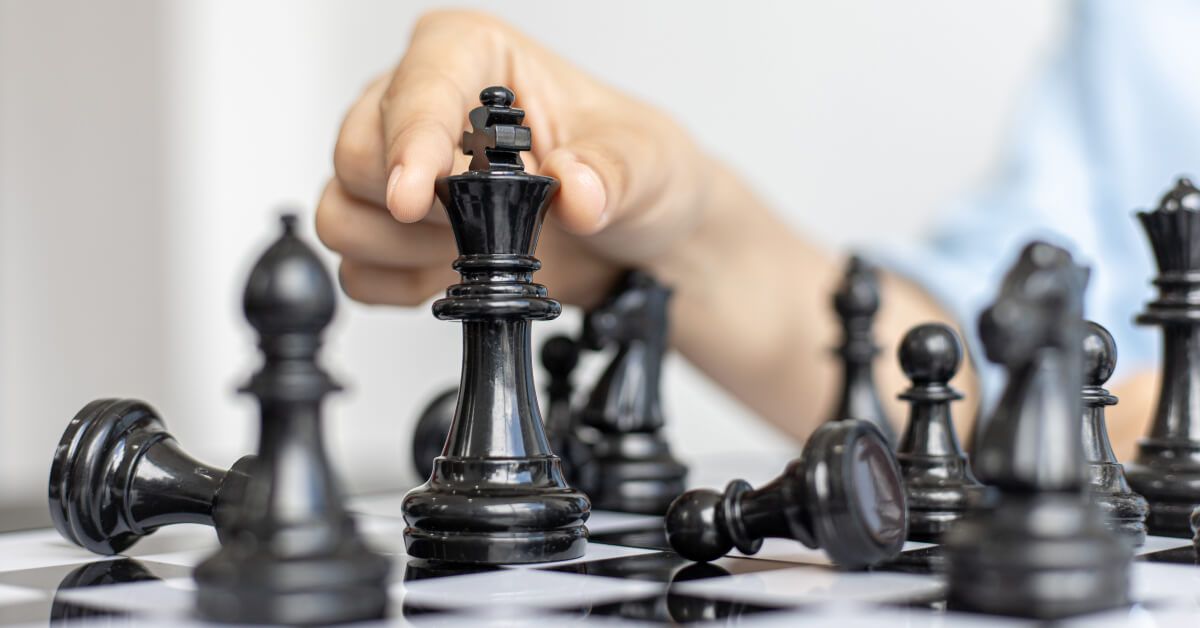 Person moving around black chess pieces