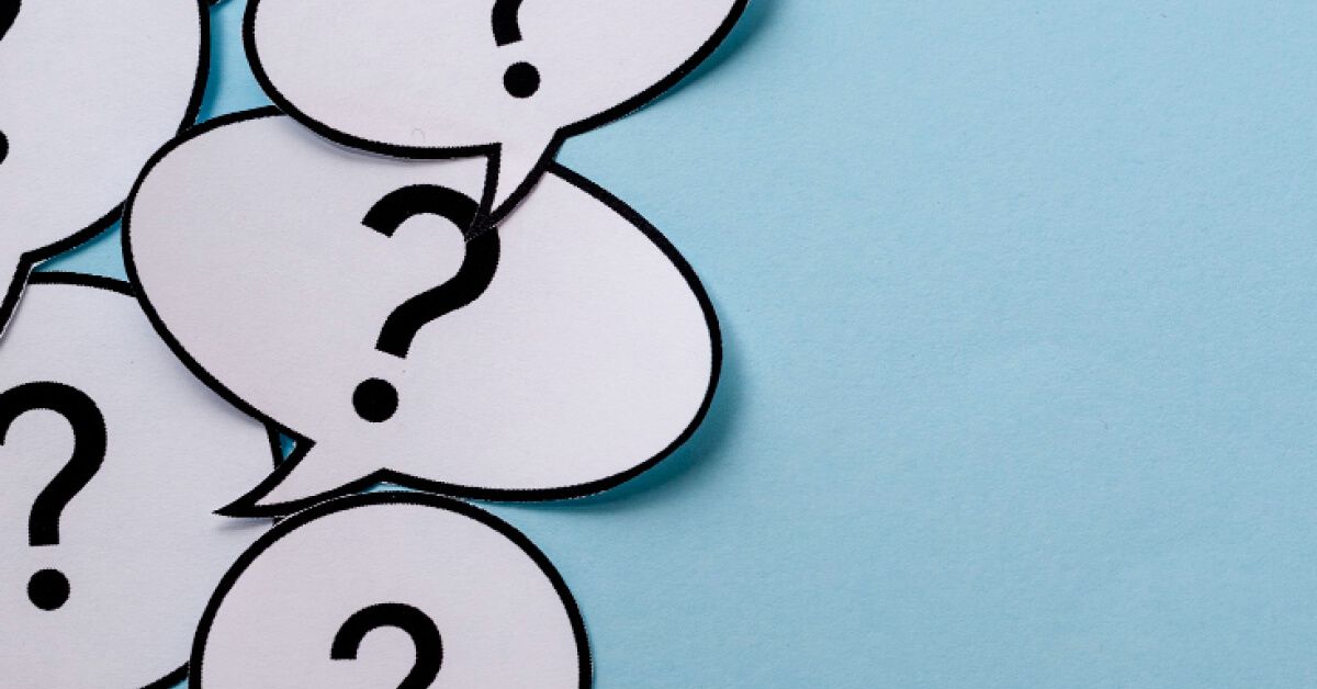 Paper cutouts of message bubbles with question marks on them